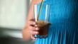 Girl is poured into a glass of fizzy lemonade.