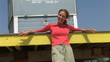 Video: Young woman leaning against lifeguard stand at beach Young woman leaning against lifeguard stand at beach