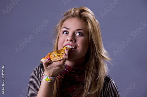 Photo: Girl eating delicious pizza. Girl eating delicious pizza.