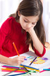 little girl drawing at home