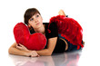 Beautiful girl lying with heart shaped red pillow Beautiful girl lying with heart shaped red pillow