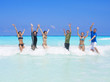 Photo: Group of people playing together in the ocean waves Group of people playing together in the ocean waves
