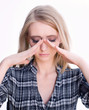 Young blonde woman with sinus pressure pain on white