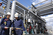 oil workers and refinery pipelines