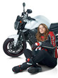 Photo: Sexy woman in a leather suit sitting at motorcycle Sexy woman in a leather suit sitting at motorcycle
