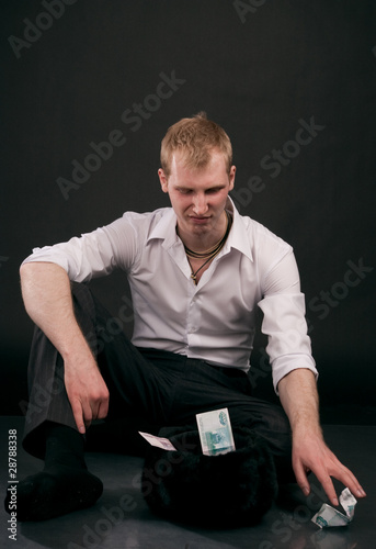 Photo: Guy with disgust counts money Guy with disgust counts money