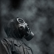 Hooded man wearing Gas mask