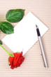 Red rose, stationery, and silver pen. Red rose, stationery, and silver pen.