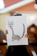 Little girl in halloween outfit shows her drawing Little girl in halloween outfit shows her drawing