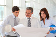 Architects meeting in hall with construction plan Architects meeting in hall with construction plan