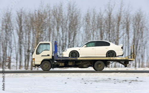 Photo: The wrecker carries the car of white color The wrecker carries the car of white color