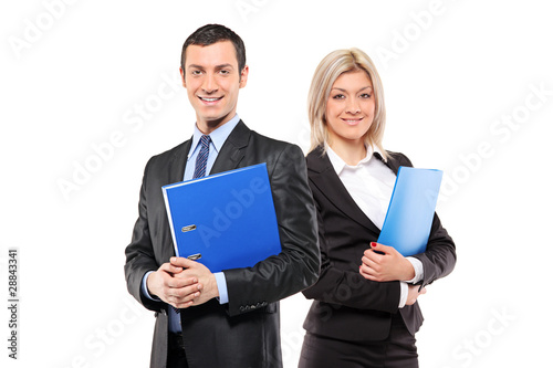 Photo: Team of happy businesspeople holding a fascicule Team of happy businesspeople holding a fascicule