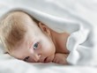 Little newborn baby lying on white blanket