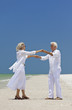 Happy Senior Couple Dancing Holding Hands on A Tropical Beach