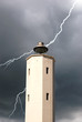 lightning behind the white lighthouse