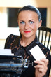 Young pretty woman sitting at a typewriter Young pretty woman sitting at a typewriter