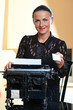 Young pretty woman sitting at a typewriter Young pretty woman sitting at a typewriter