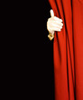 Magician behind red curtain