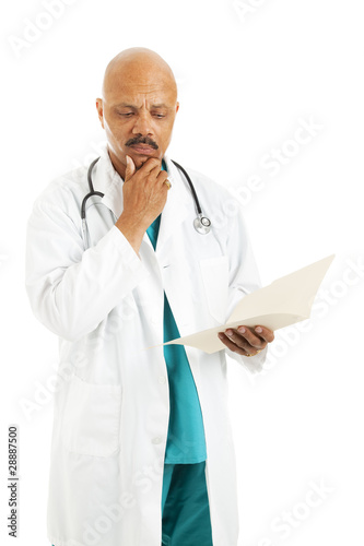 Photo: Doctor Reviews Patient Chart Doctor Reviews Patient Chart