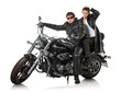 Photo: Couple in a black leather sitting on black custom motorcycle Couple in a black leather sitting on black custom motorcycle