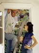 Man Taking A Break From Painting The Outside Of His House