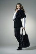 Fashion girl with bag posing in the studio