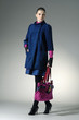 Fashion girl with bag posing in the studio