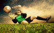 Jump of football goalman on the outdoor field