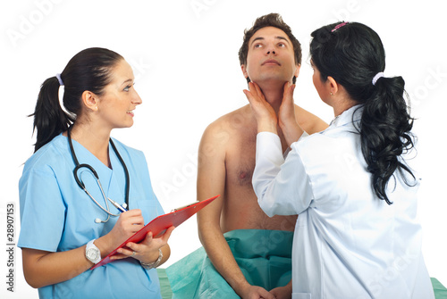 Photo: Doctor examine thyroid male patient Doctor examine thyroid male patient