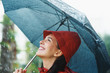 Woman smiling under umbrella