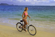 blond girl in pink bikini riding her bike on the beach in hawaii blond girl in pink bikini riding her bike on the beach in hawaii