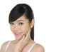 asian woman pampering her face by beauty slender fingers