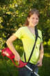 Girl works with  grass-cutter