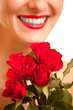 Beautiful caucasian woman with red roses on white isolated backg