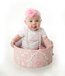Pretty baby sitting in a hatbox