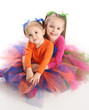 Sisters in bright tutu skirts