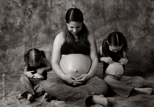 Photo: Pregnant mom and little girls comparing bellies Pregnant mom and little girls comparing bellies