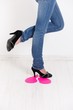 Sexy legs trampling on pink paper heart