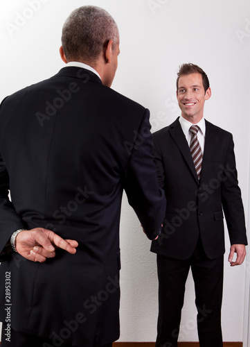 Photo: Crossed Fingers At Handshake Crossed Fingers At Handshake