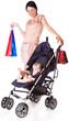 a young woman is standing near a pram and holding bright paper b
