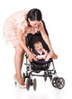 a young woman is standing near her child in a pram
