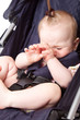 a crying child is in a pram