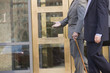 Two businessmen walking in front of a bank
