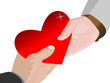A male hand and a female hand hold a red heart