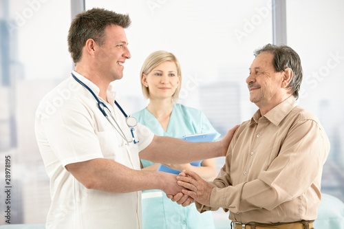 Photo: Doctor shaking hands with senior patient Doctor shaking hands with senior patient