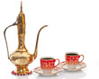 Arabic brass coffee pot with a welcoming cups full of coffee. Arabic brass coffee pot with a welcoming cups full of coffee.