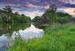 Spring landscape at sunset with watermill and river