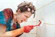 angry woman cleaning bathroom with brush
