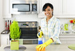 Young woman cleaning kitchen