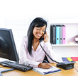 Smiling black businesswoman on phone at desk Smiling black businesswoman on phone at desk